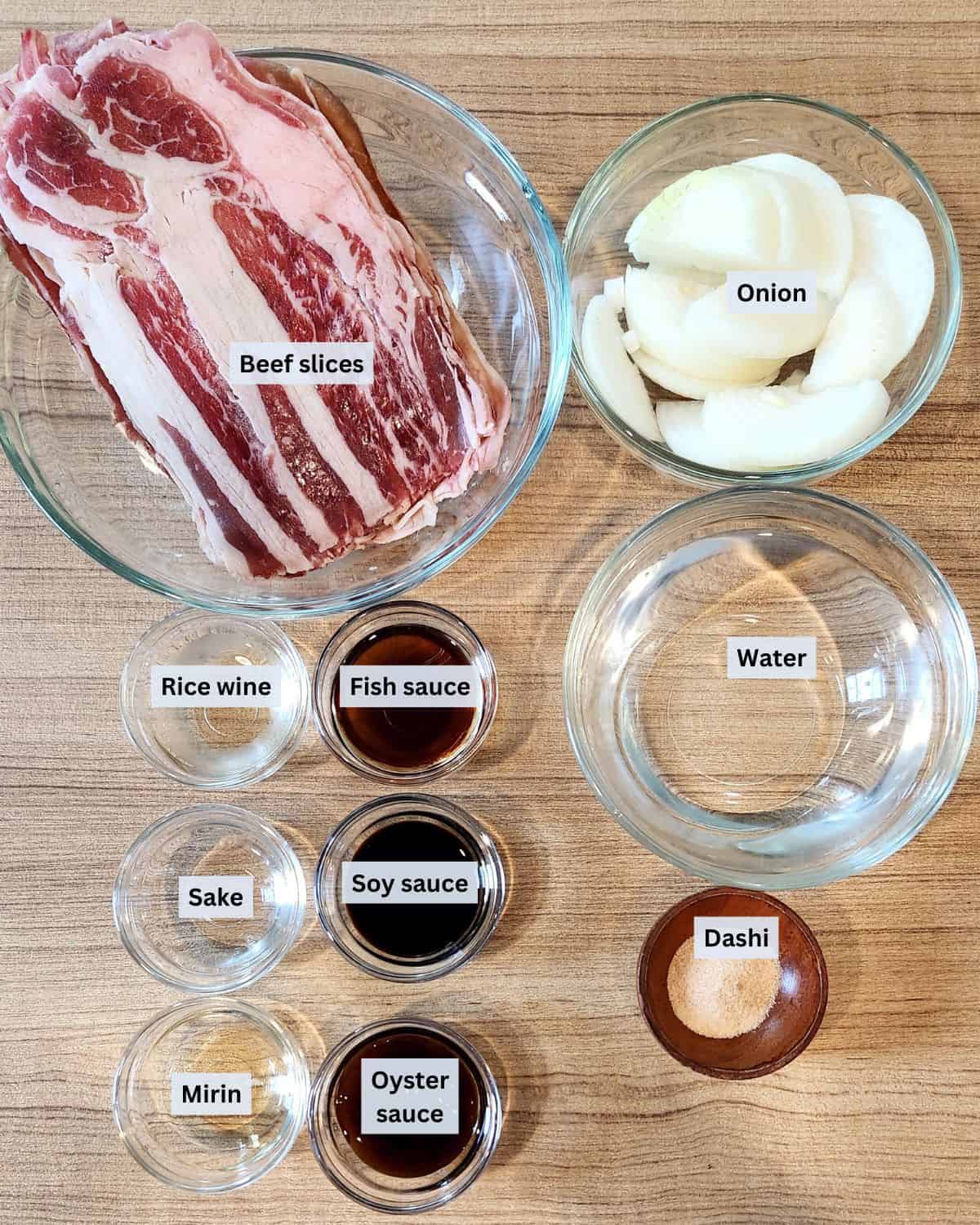 Yoshinoya gyudon beef ingredients in small bowls with labels.
