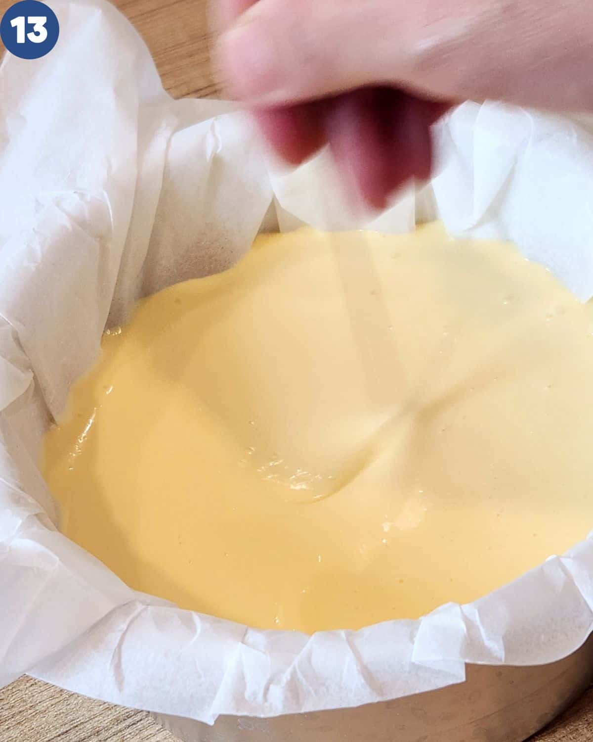 Process photo of stirring the batter in the baking pan to let the air bubble out.