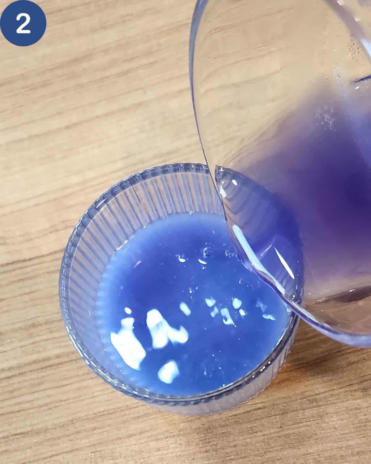 A photo of butterfly pea flower tea poured into a glass.