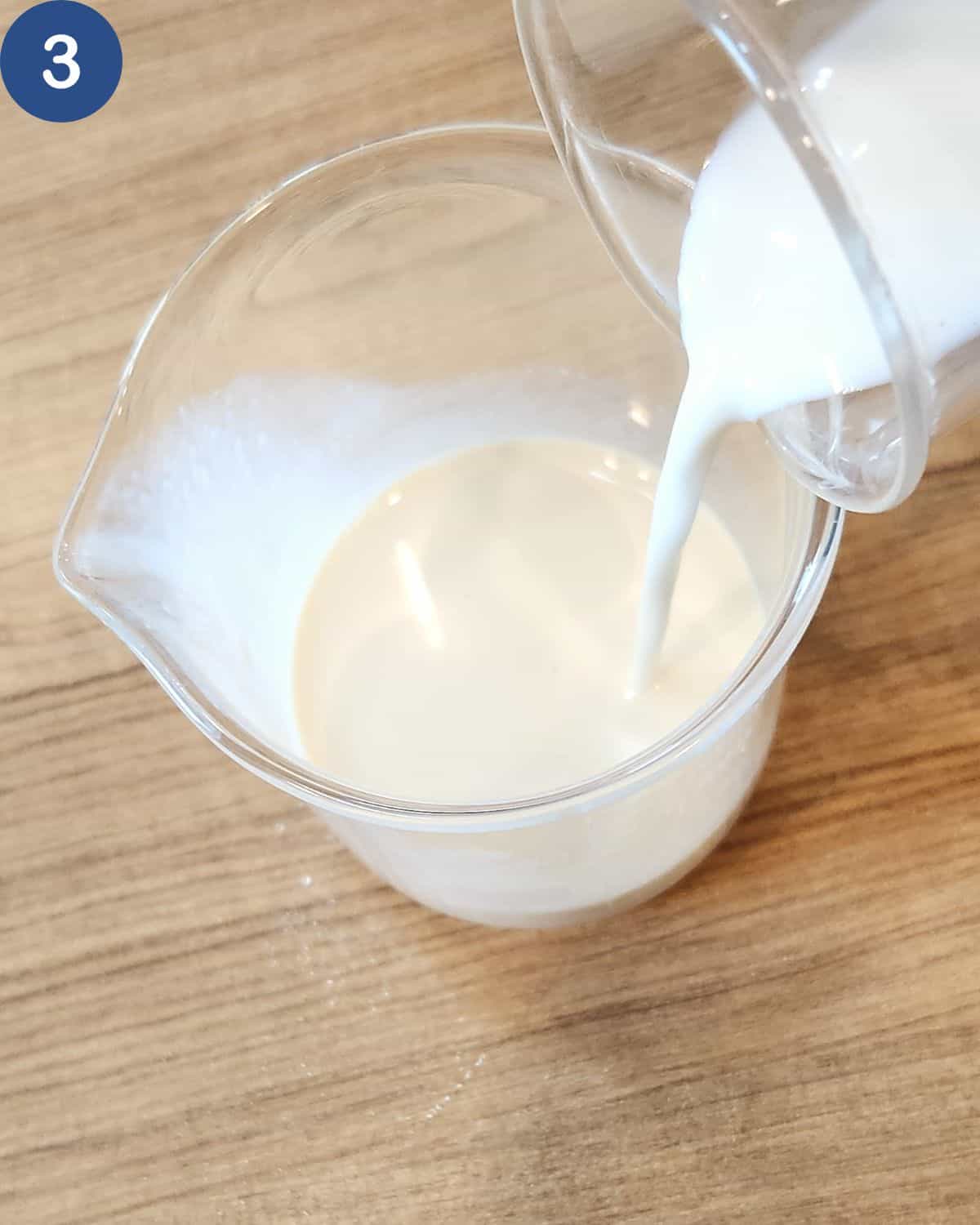 A photo of fresh milk combined into evaporated milk in a glass.