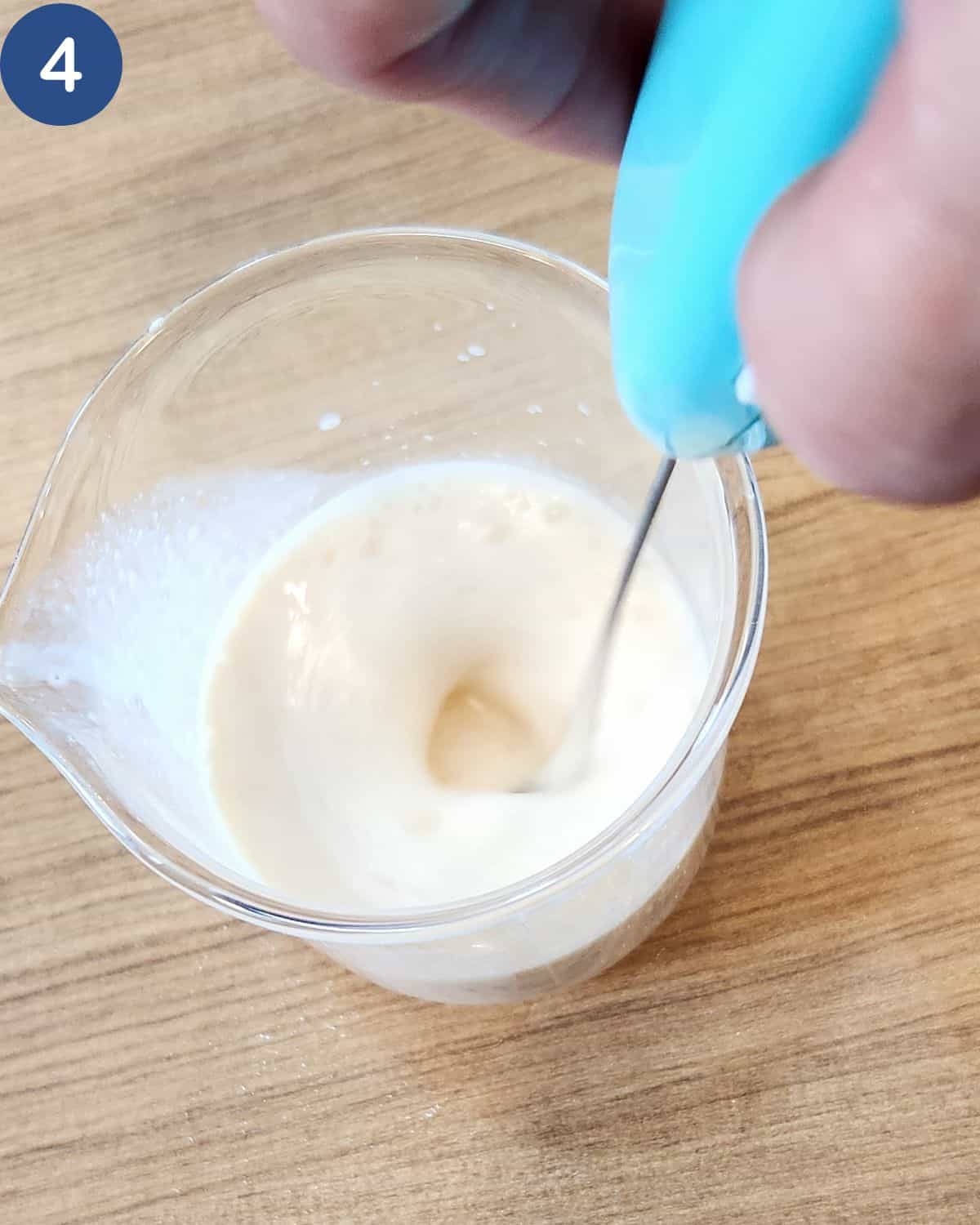 A photo of milk being frothed with a milk frother.