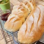 A photo of two loaves Japanese milk hearth bread, one slices, one whole.