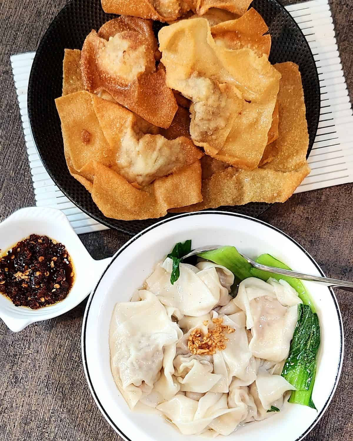 A plate of fried chicken shrimp wontons and a bowl of boiled chicken shrimp wonton soup.