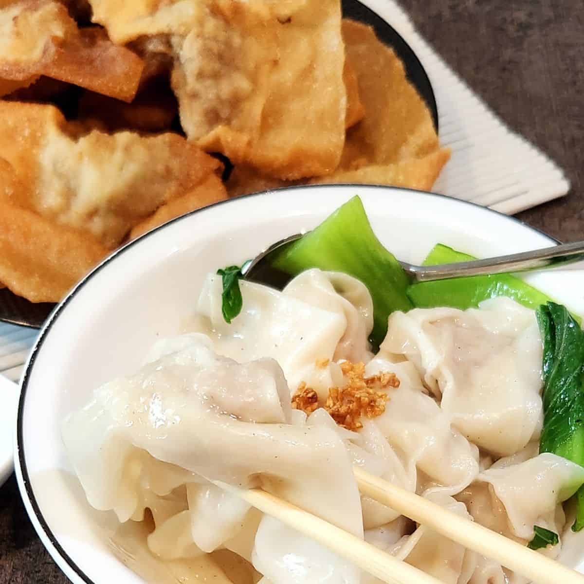 A plate of fried chicken shrimp wontons and a bowl of boiled chicken shrimp wontons soup.