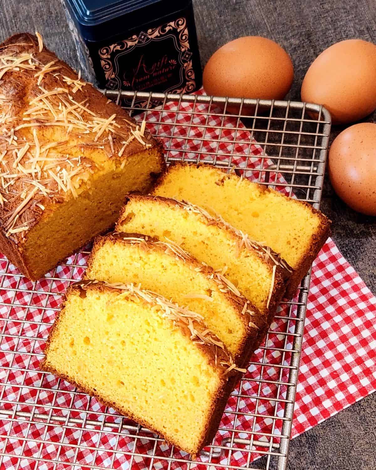 A photo of several slices of fermented cassava cake on a cooling rack.