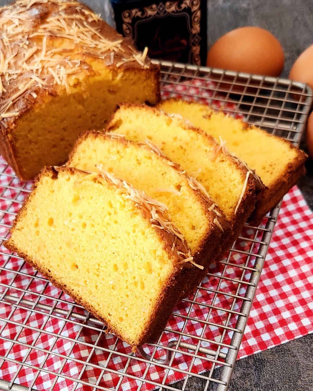 A photo of several slices of fermented cassava cake on a cooling rack.