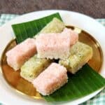 A few slices of Kue Awuk with two colors on banana leaves and golden plate.