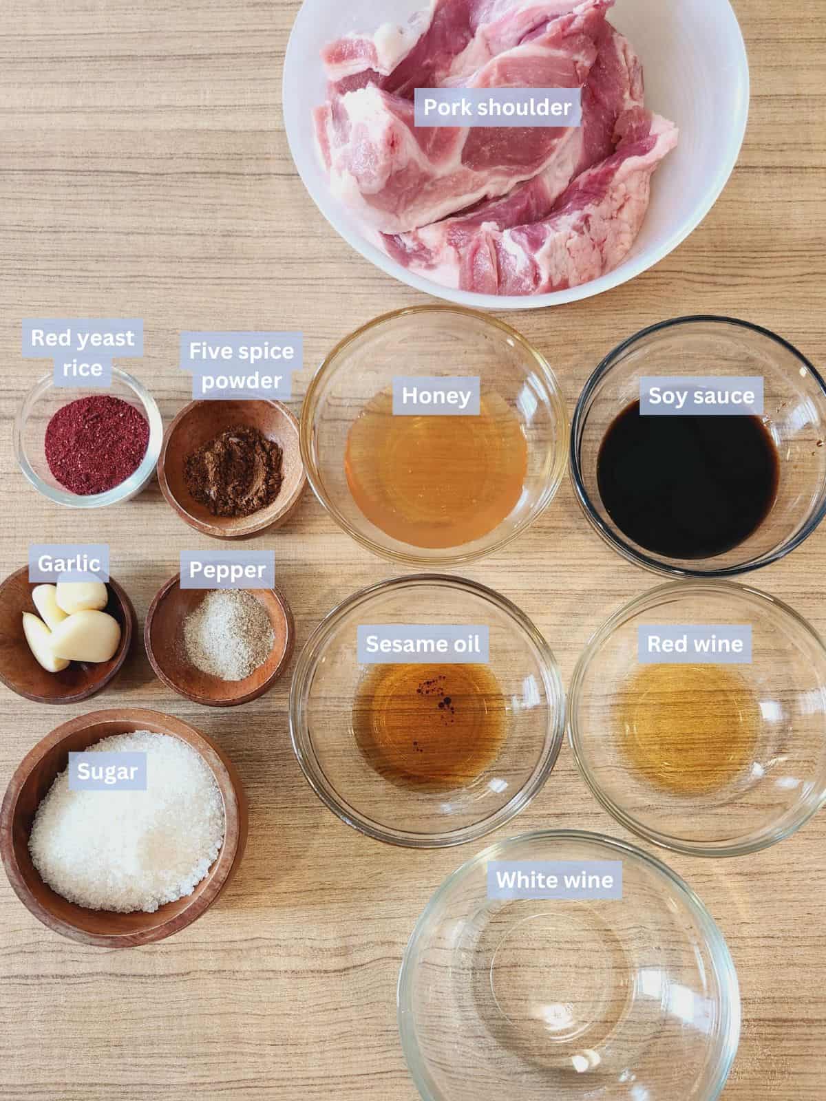 Char siu roast pork ingredients with labels on a table.