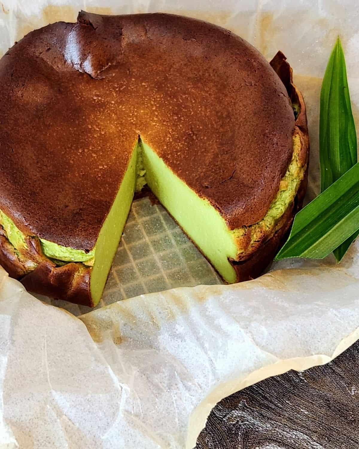 A photo of pandan basque cheesecake on parchment paper.