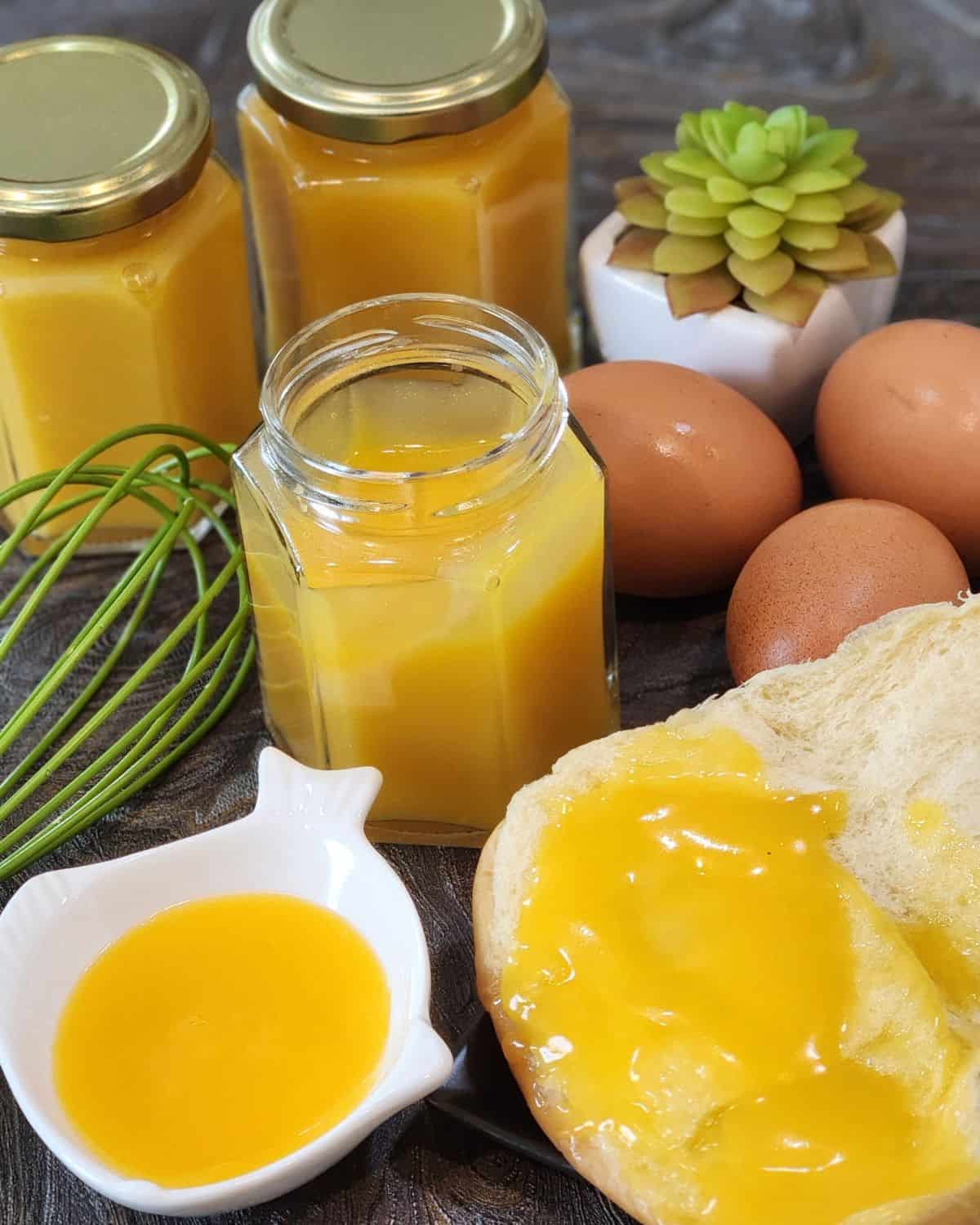 Eggs, bread, and coconut kaya jam on a granite table.