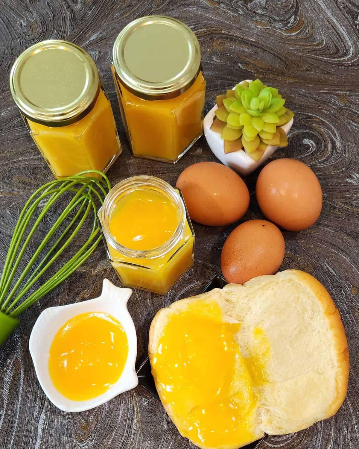 Eggs, bread, and butter on a wooden table.