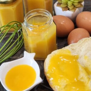 Eggs, bread, and coconut jam on a granite table.