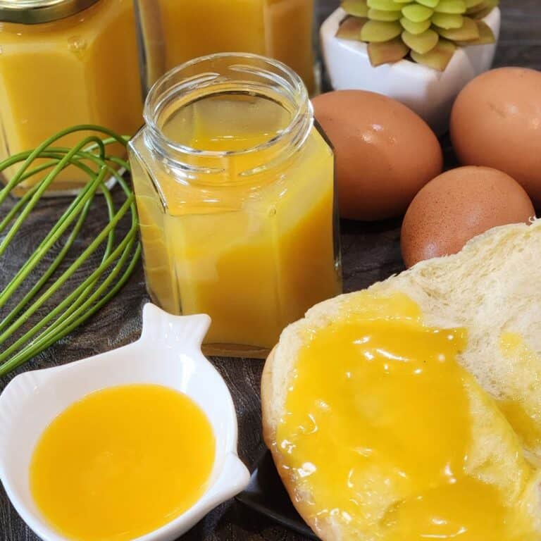 Eggs, bread, and coconut jam on a granite table.