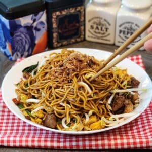 A plate of Mie Goreng, Indonesian stir fried noodles with chopsticks.