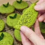 Two hands holding Mini Bika Ambon Pandan with its honeycomb texture.