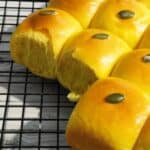Pumpkin coconut bread with its yellow golden color on a cooling tray.