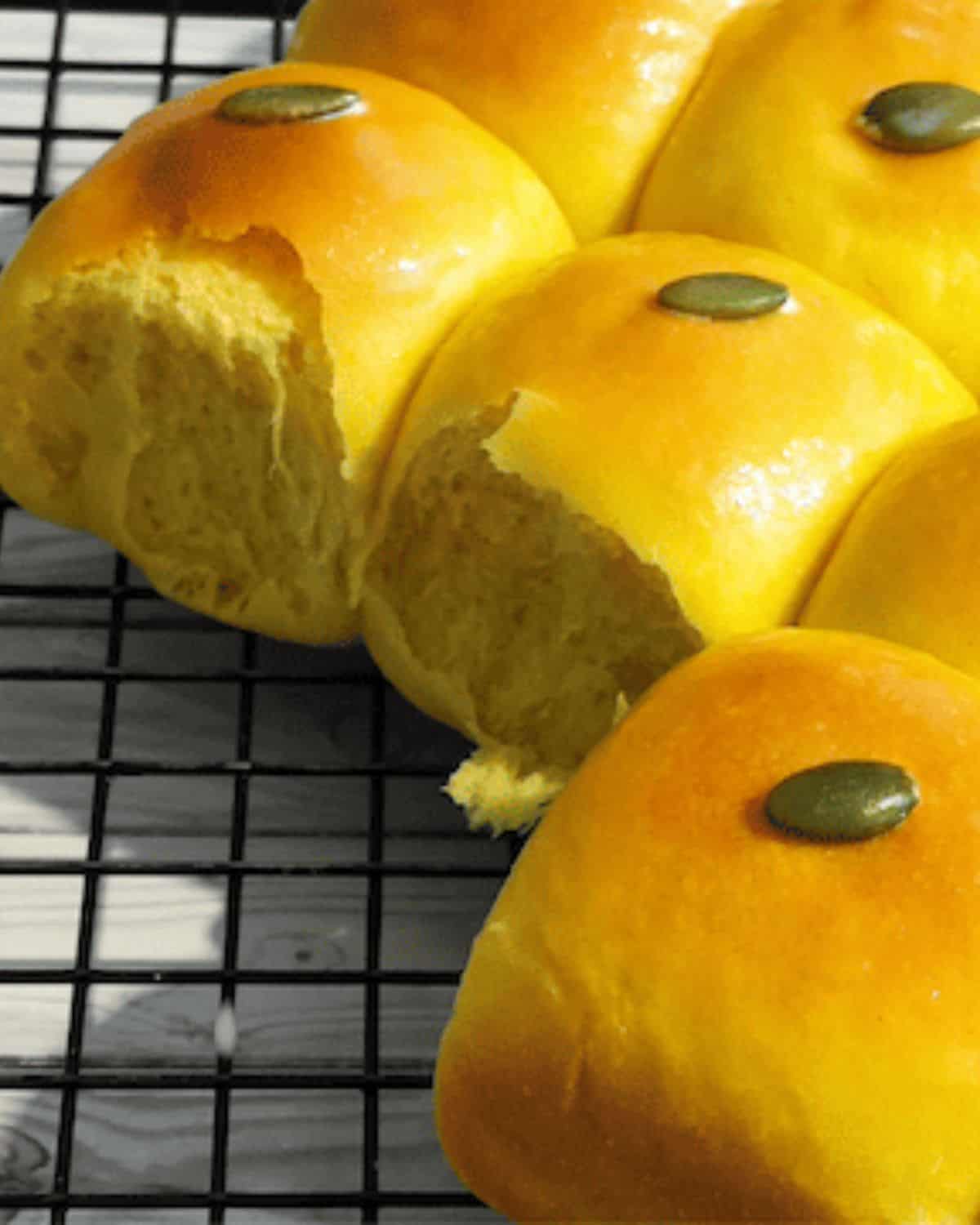 Pumpkin coconut bread with its yellow golden color on a cooling tray.