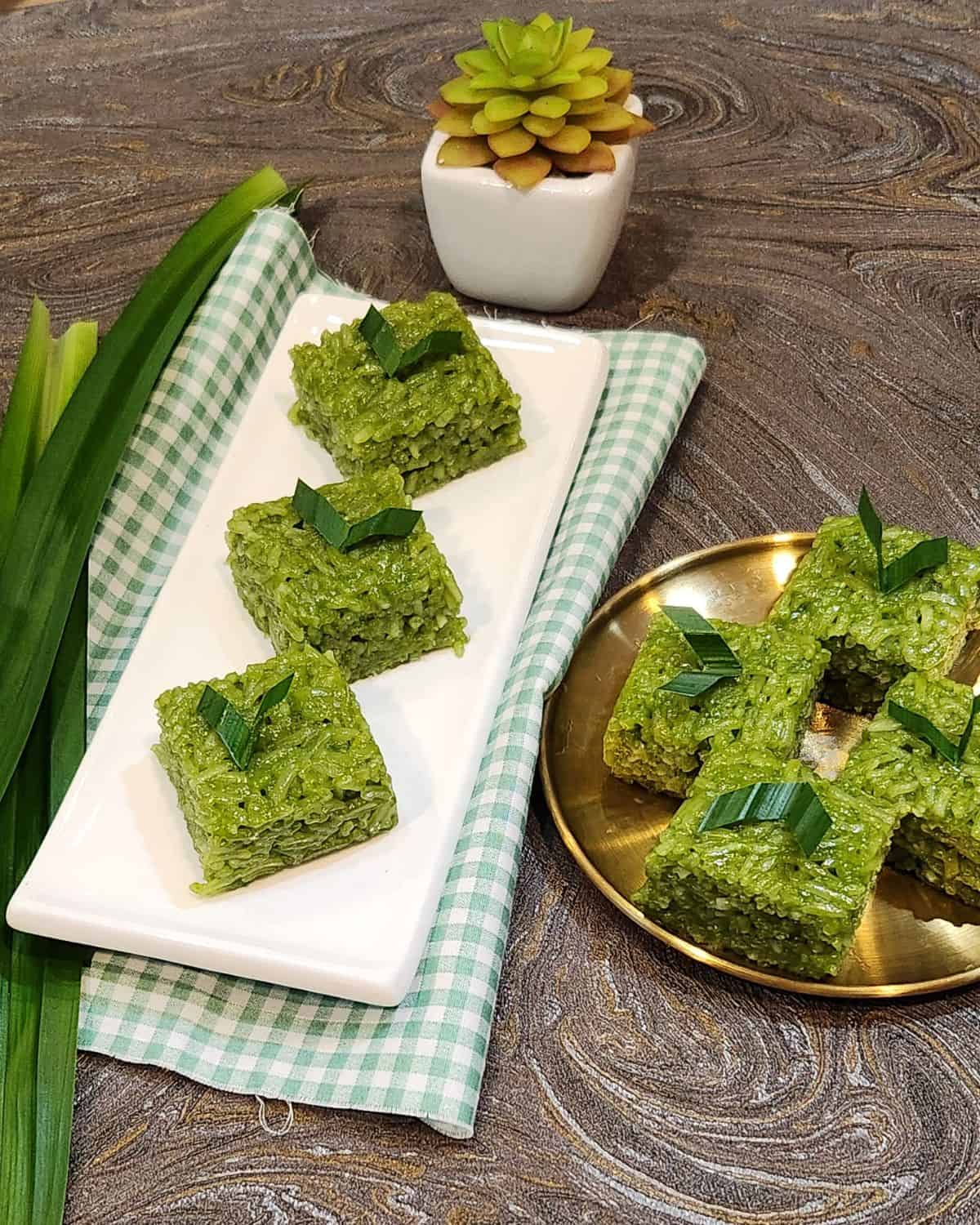A rectangular white plate of pandan wajik.