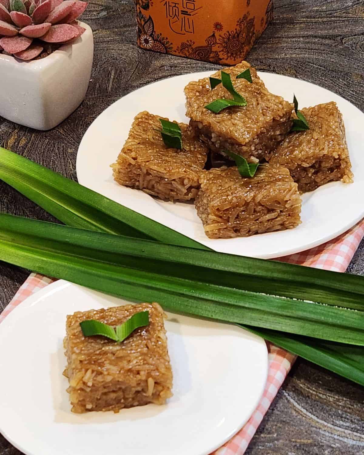 Coconut sugar wajik or palm sugar wajik on a plate with pandan leaves.