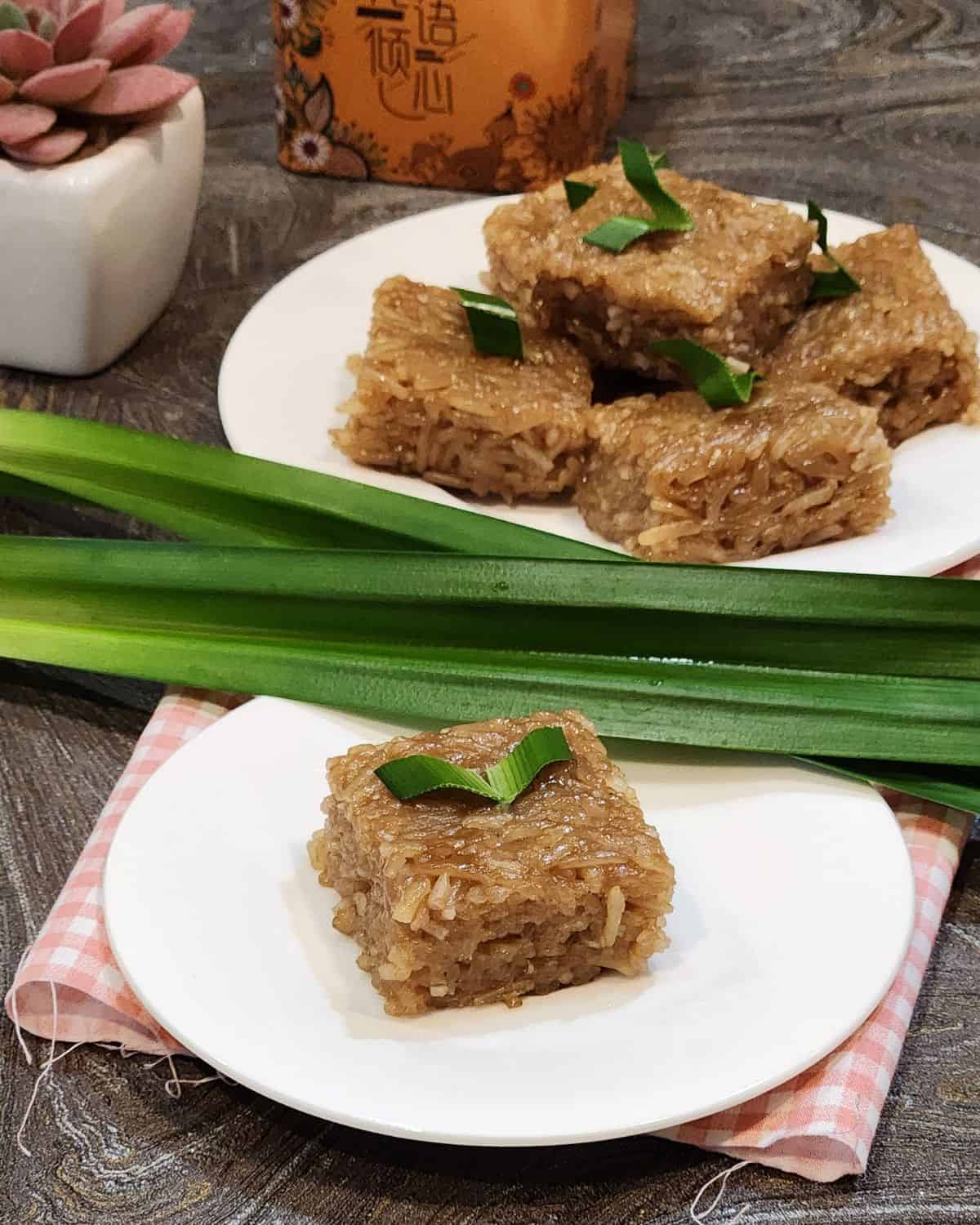 Coconut sugar wajik or palm sugar wajik on a plate with pandan leaves.