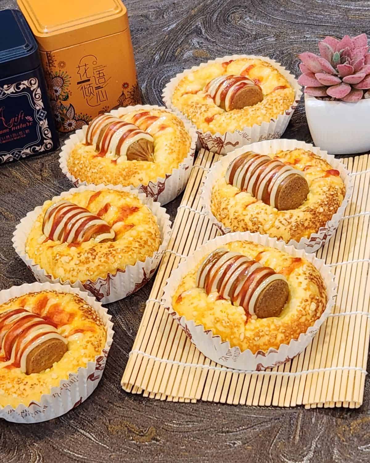 A few of Korean sausage bread on a bamboo tray.
