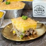 A slice of pastel tutup on a golden plate.