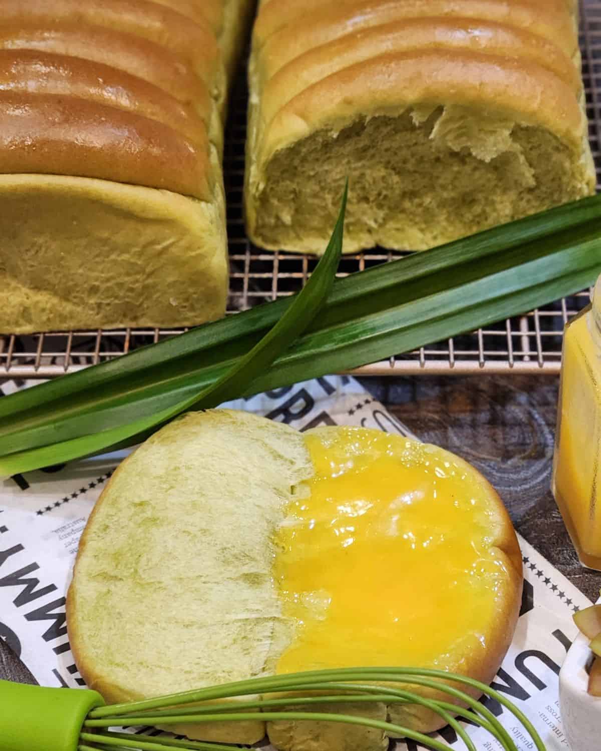 Two slices roti sisir pandan opened with coconut kaya jam.