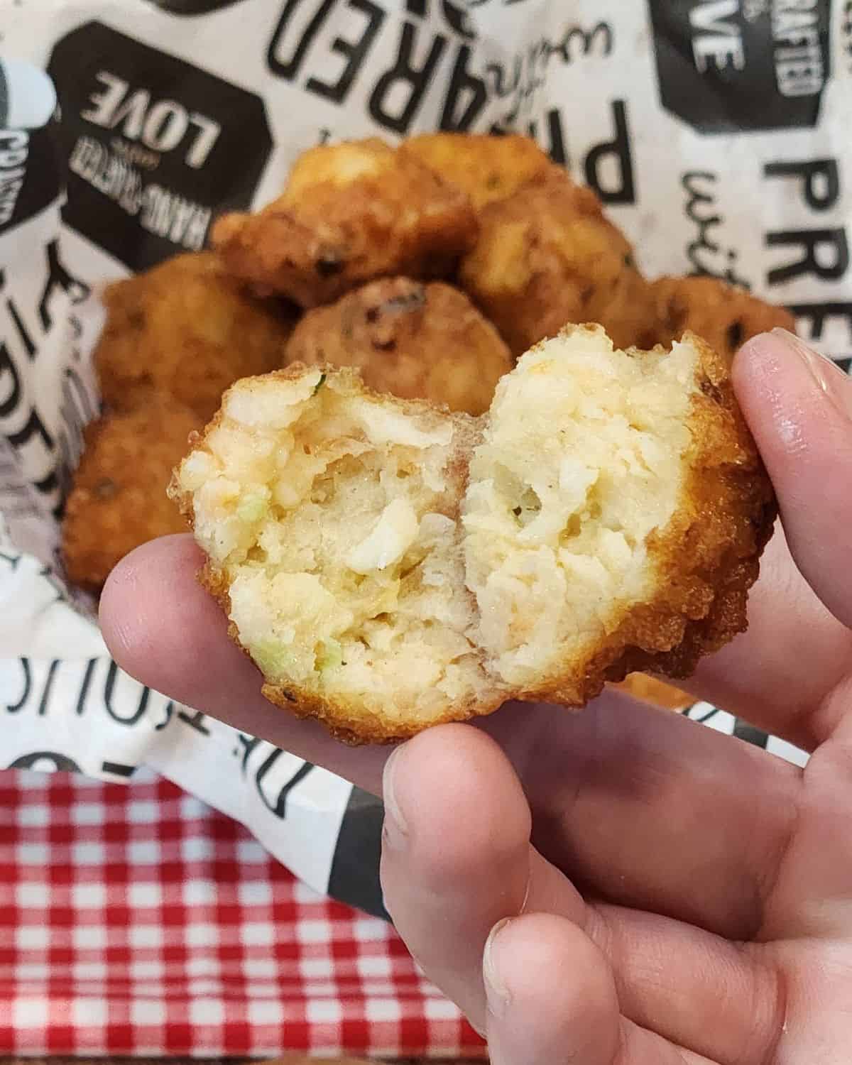 Shrimp balls held open with a hand.