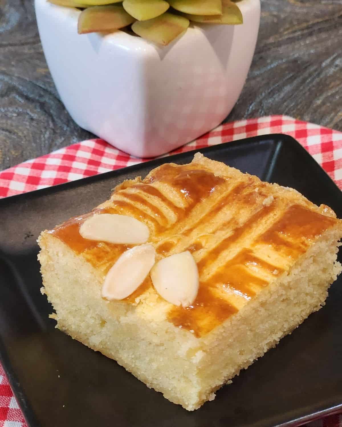 A slice of Dutch Butter Cake or Boterkoek on a small plate.