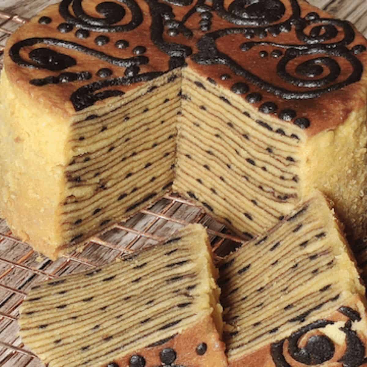 Lapis legit on a wire rack cut into slices.