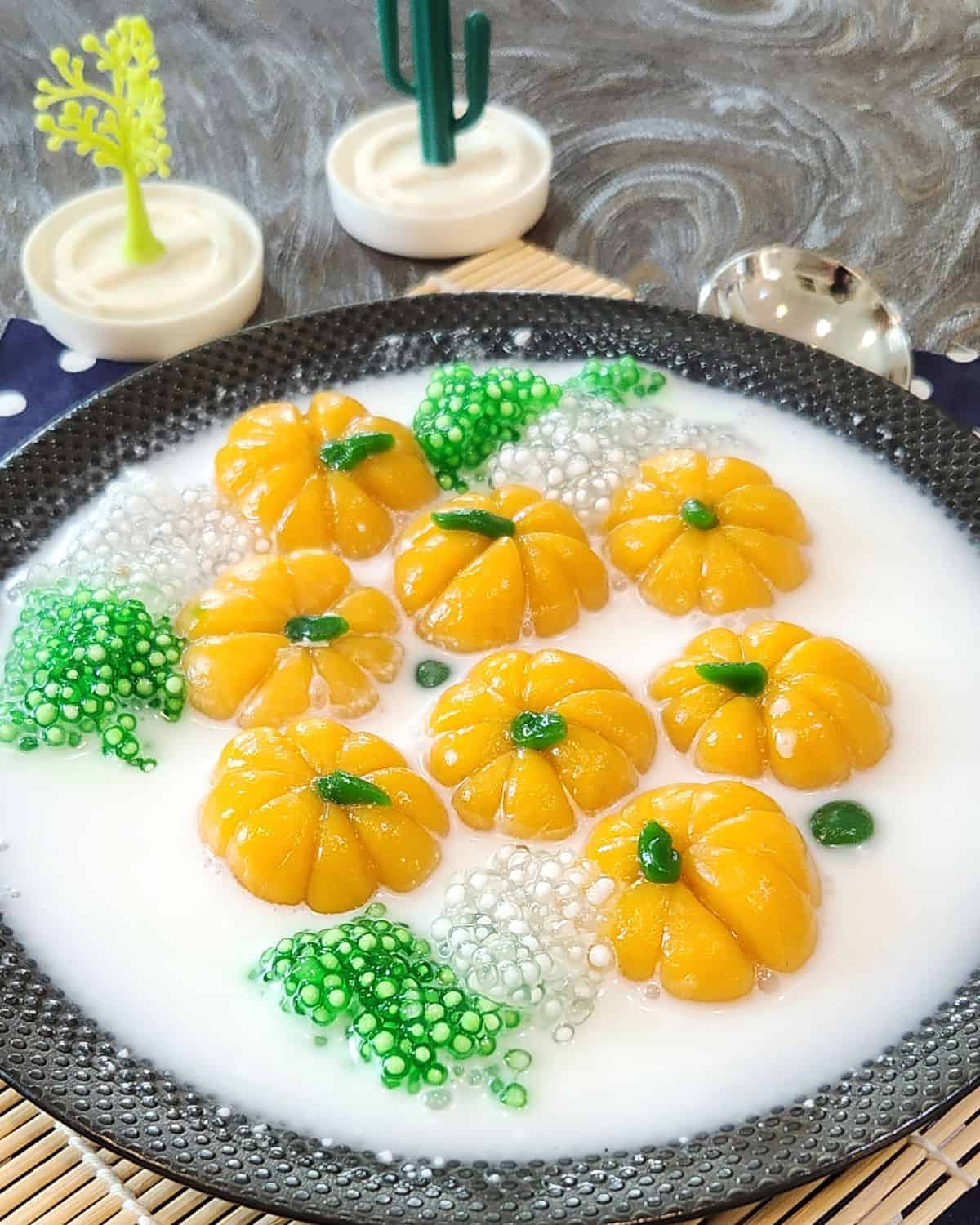 A bowl of bua loy, pumpkin glutinous rice balls with coconut milk sauce.