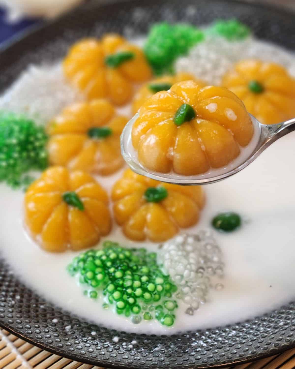 A piece of bua loy in pumpkin shape in spoon.