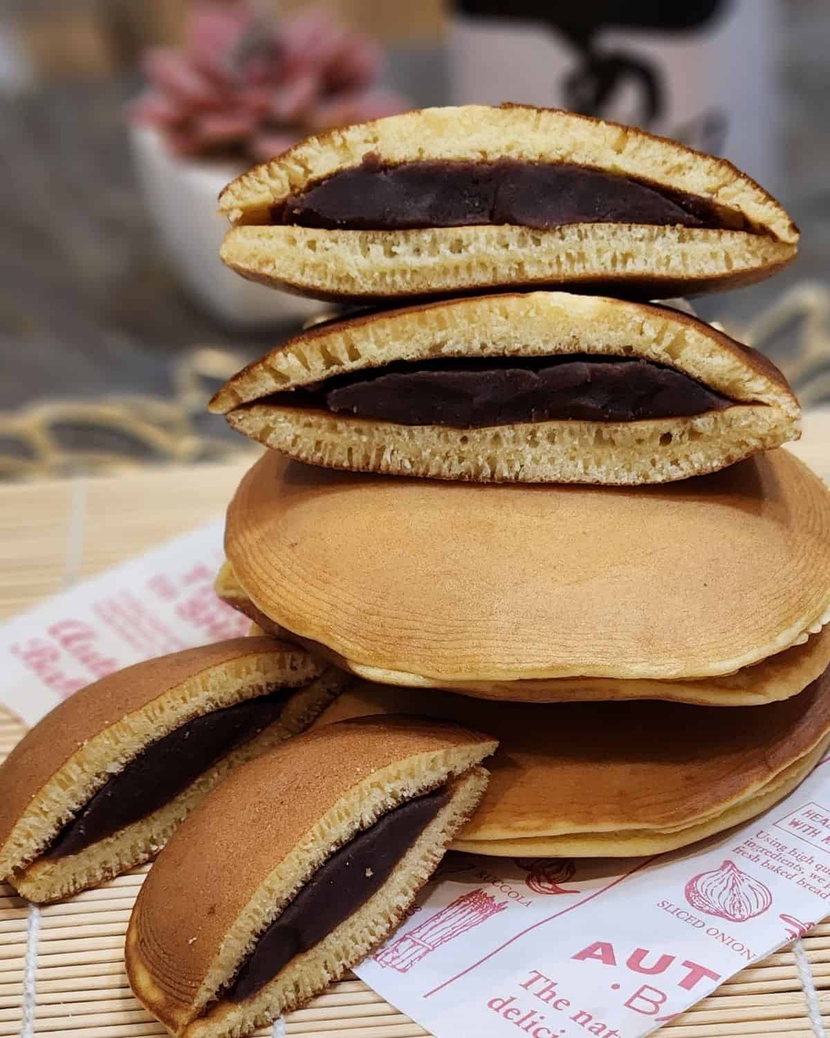 A stack of sliced Japanese Dorayaki on parchment paper.