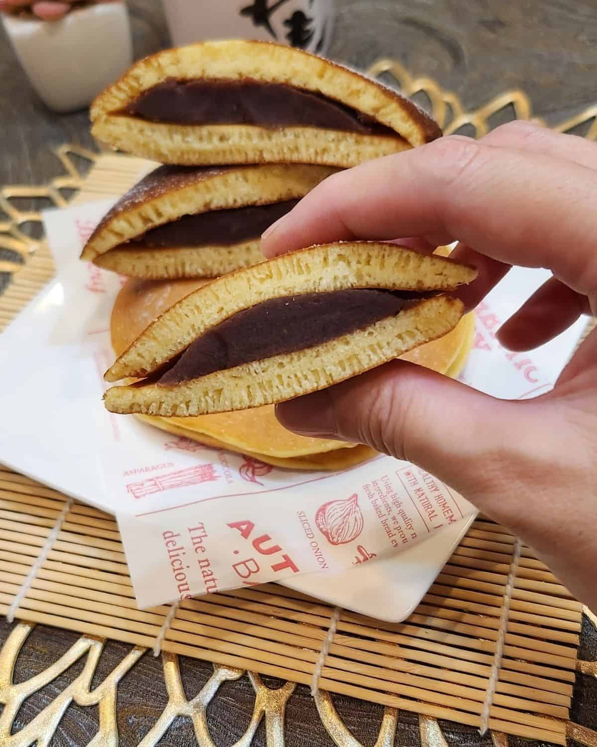 A slice of Japanese dorayaki with red bean filling.