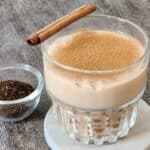 A glass of Assam Milk Tea with tapioca pearls and cinnamon ground topping.