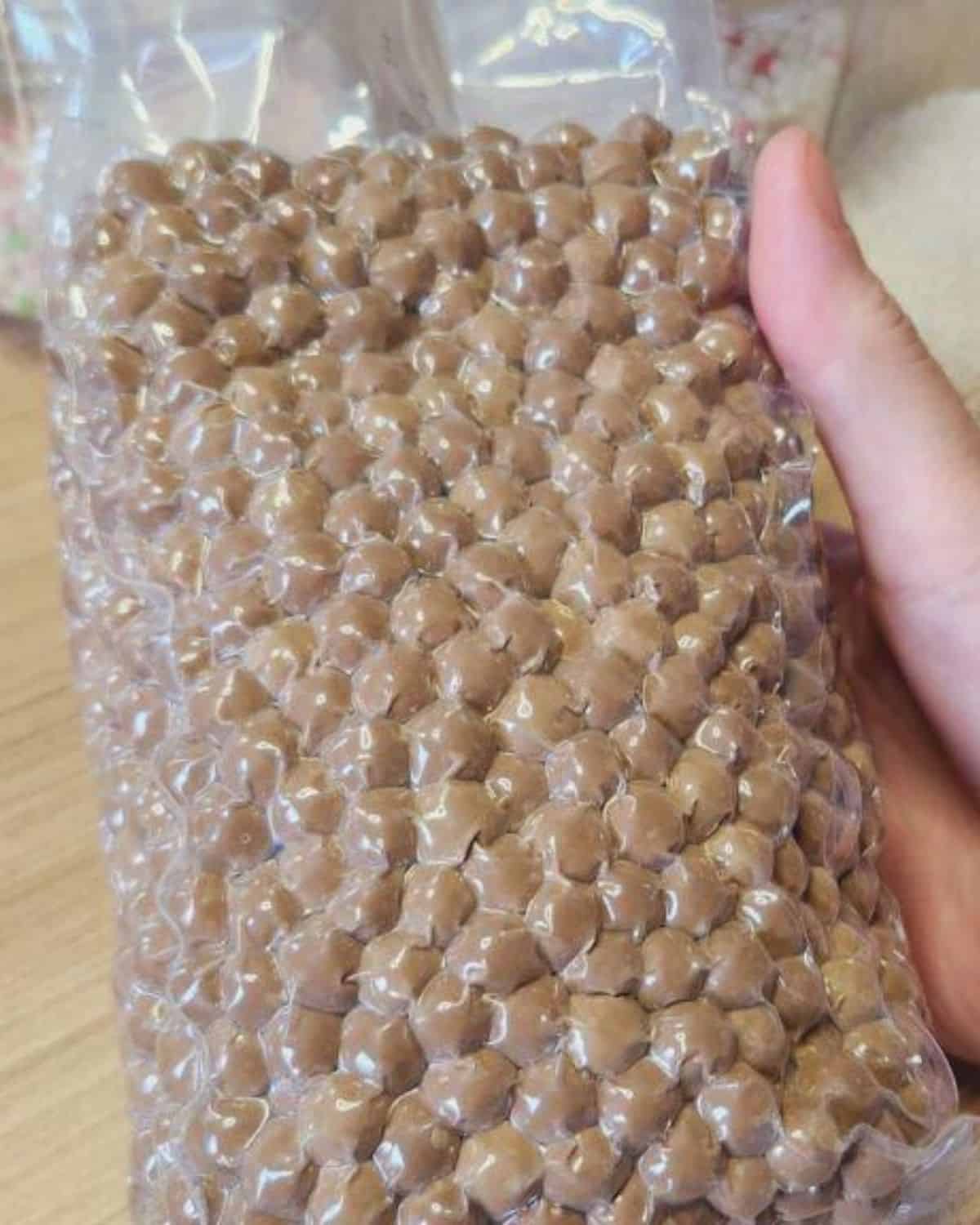 Brown tapioca pearls in a plastic bag.