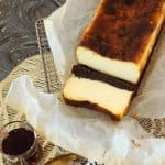 A loaf of brownie burnt basque cheesecake on a parchment paper.