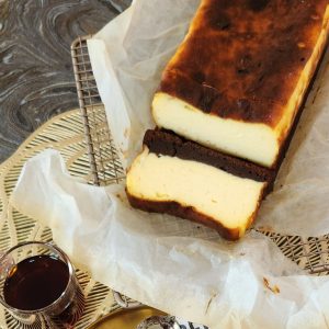 A loaf of brownie burnt basque cheesecake on a parchment paper.