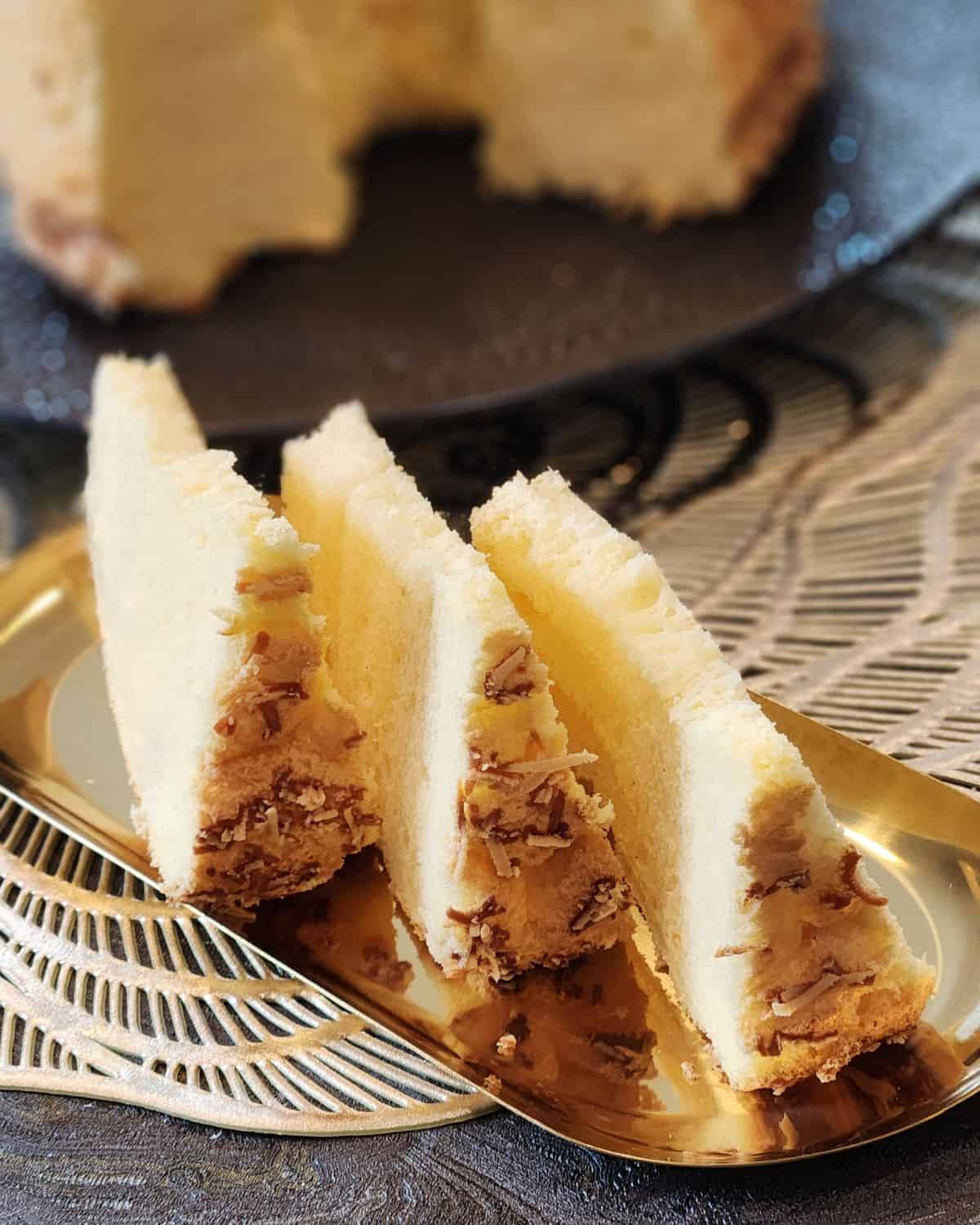 Three slices of cheese chiffon cake on a golden plate.