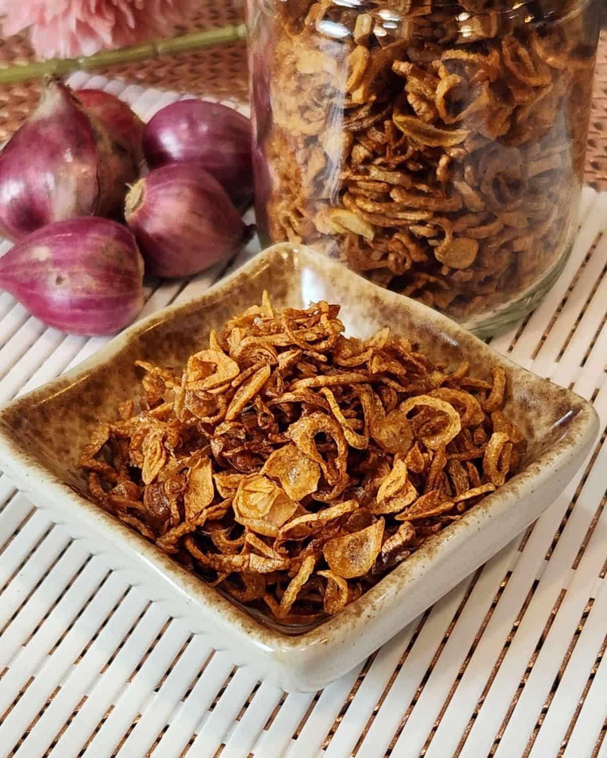 A small stack of fried shallots that are crunchy and golden brown.