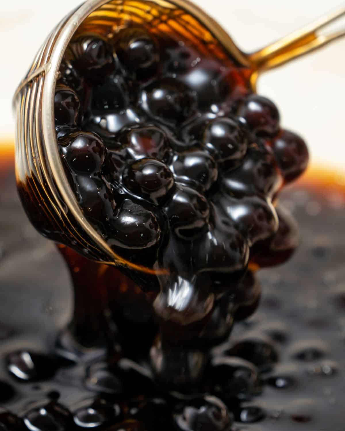Cooked tapioca pearls in brown sugar syrup.