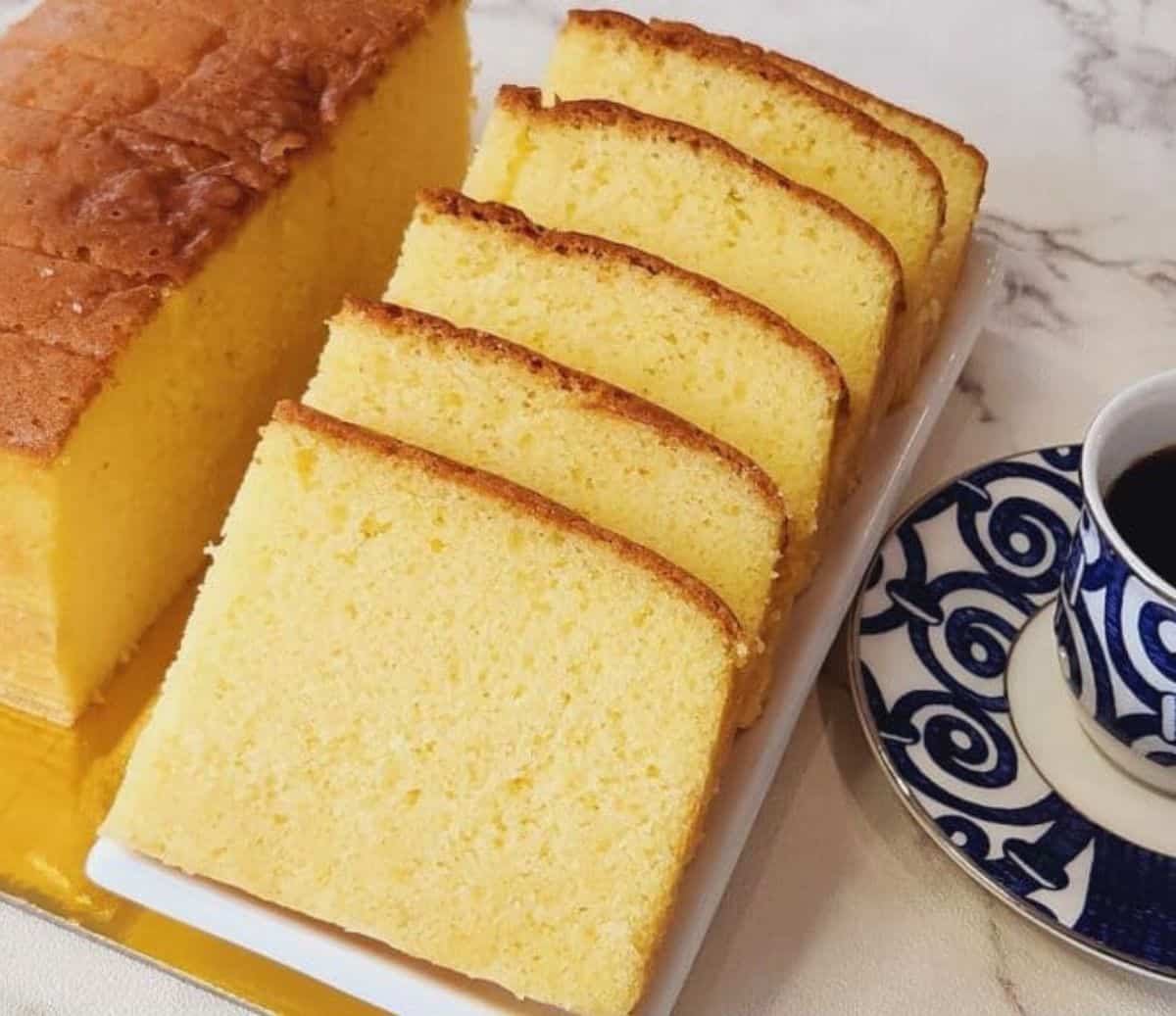 A photo of Thai butter cake slices on a white plate.