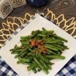 A plate of sautéed green beans with garlic.