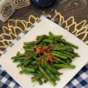 A plate of sautéed green beans with garlic.