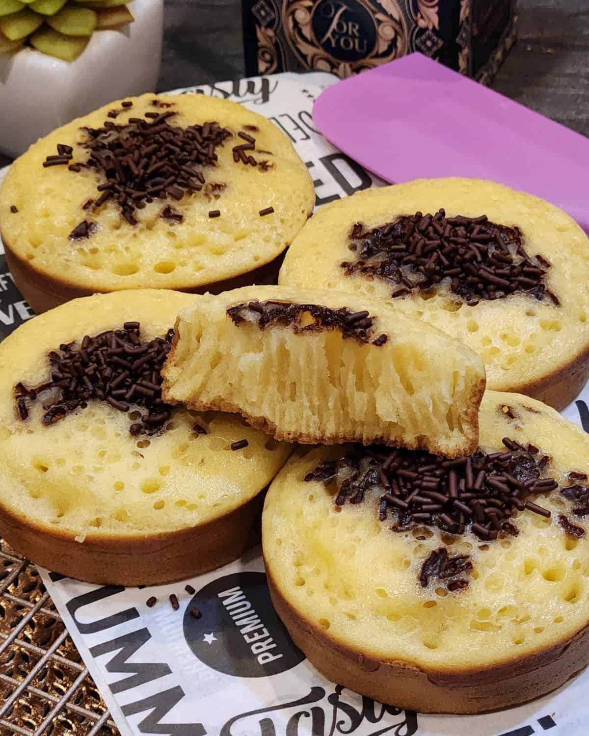 A few Thai egg cake with chocolate topping on parchment paper.