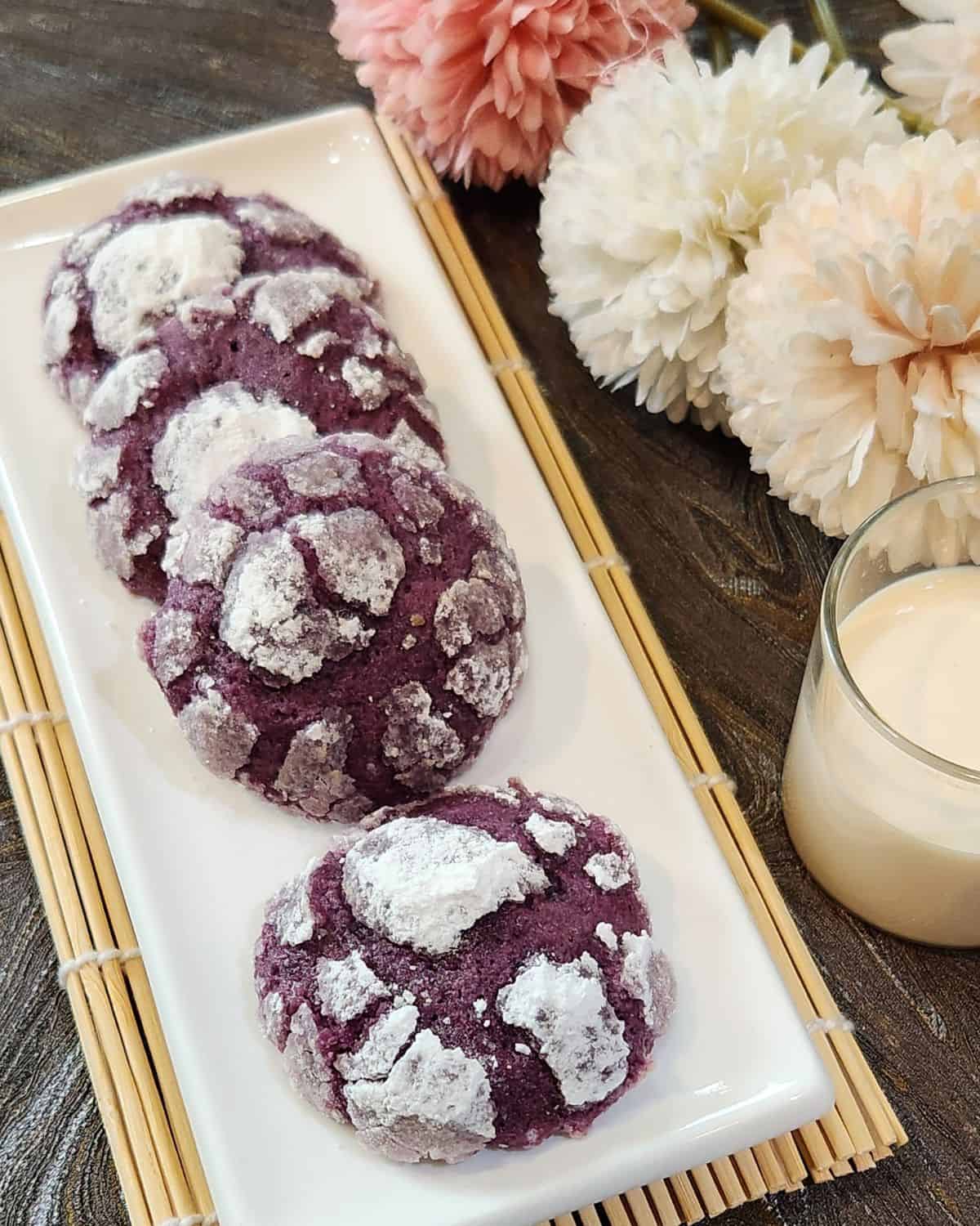 A few Ube crinkle cookies on a white plate.