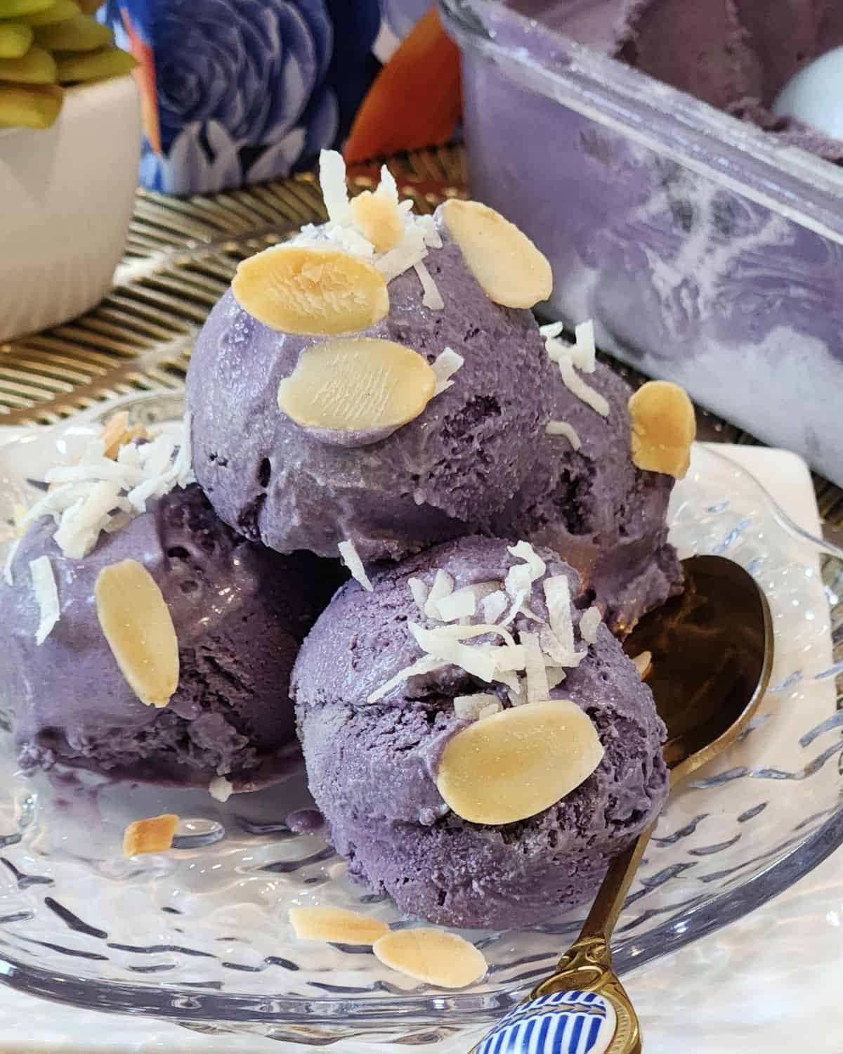 Homemade ube ice cream sprinkled with coconut and almond slices.