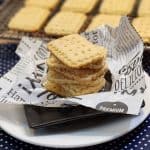 A stack of cheese cookies on a ruffled parchment paper.