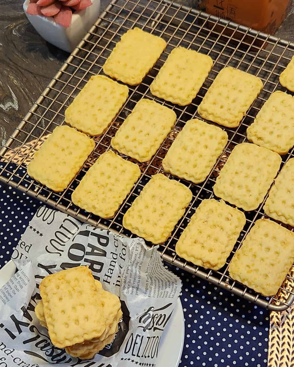 Cheese cookies lined up on a wire rack.