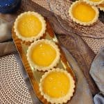 Hong Kong style egg tarts on a golden plate.